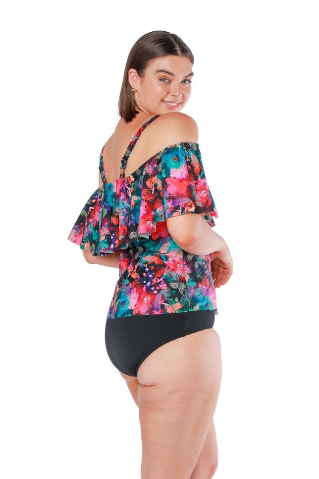 Side shot of model wearing tankini top in pink and blue floral print