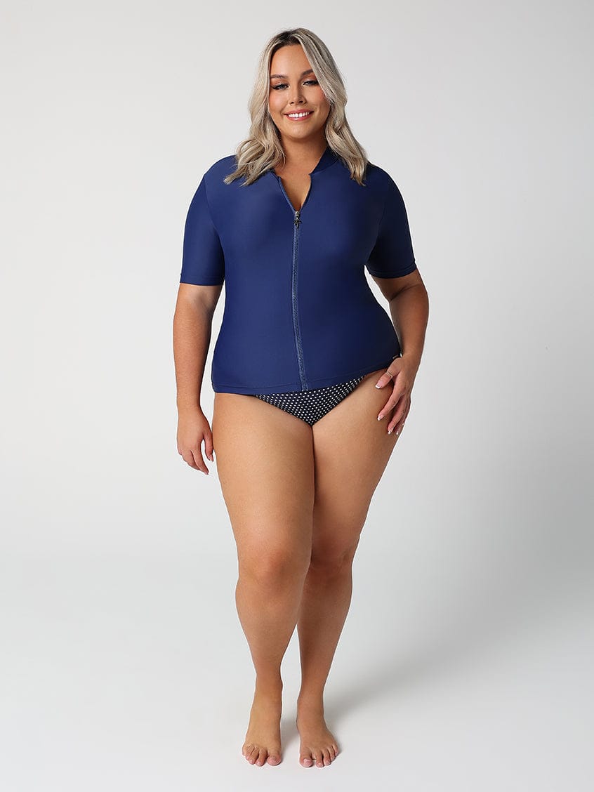 Woman wearing a blue swimsuit with a white background