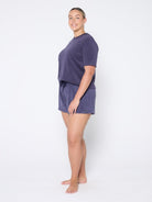 Woman wearing a navy terry set on a white background