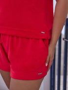 Red shorts with a pocket detail on a person, blurred background