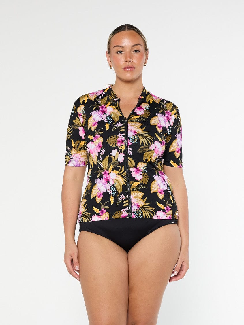 Blonde model shows pink and gold floral pool proof rashie with full front zip and short sleeves