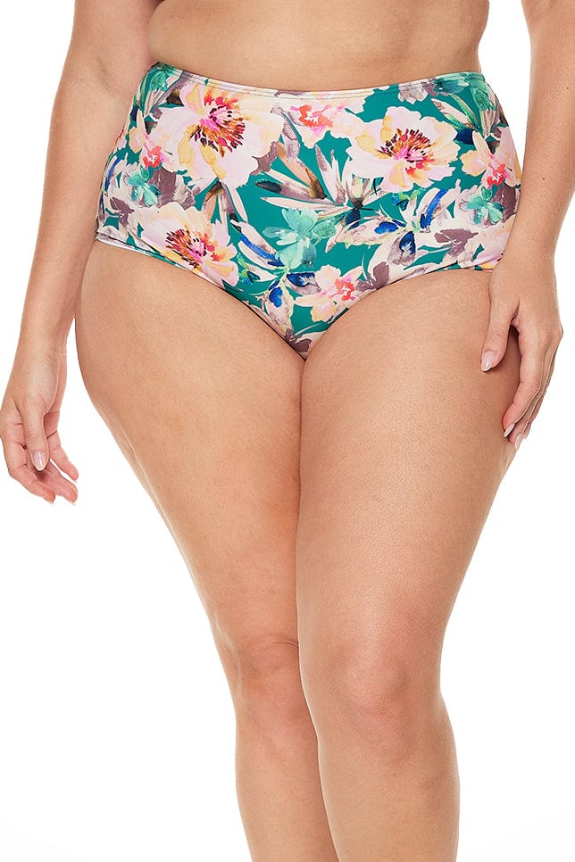 Blonde model wears high waisted green and pink floral bikini bottoms