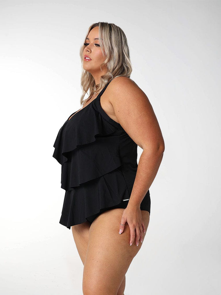 Blonde model wears black 3 tier ruffle tankini top in chlorine resistant fabric