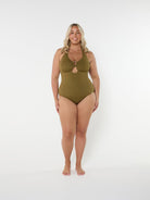 Woman wearing a green swimsuit on a white background