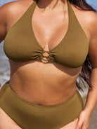 Person wearing a green bikini at the beach