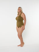 Woman wearing a green swimsuit on a white background