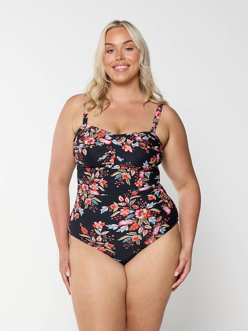model wearing black and red floral one piece