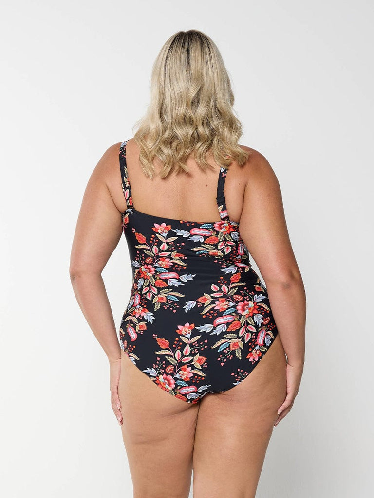model wearing black and red floral full coverage swimsuit