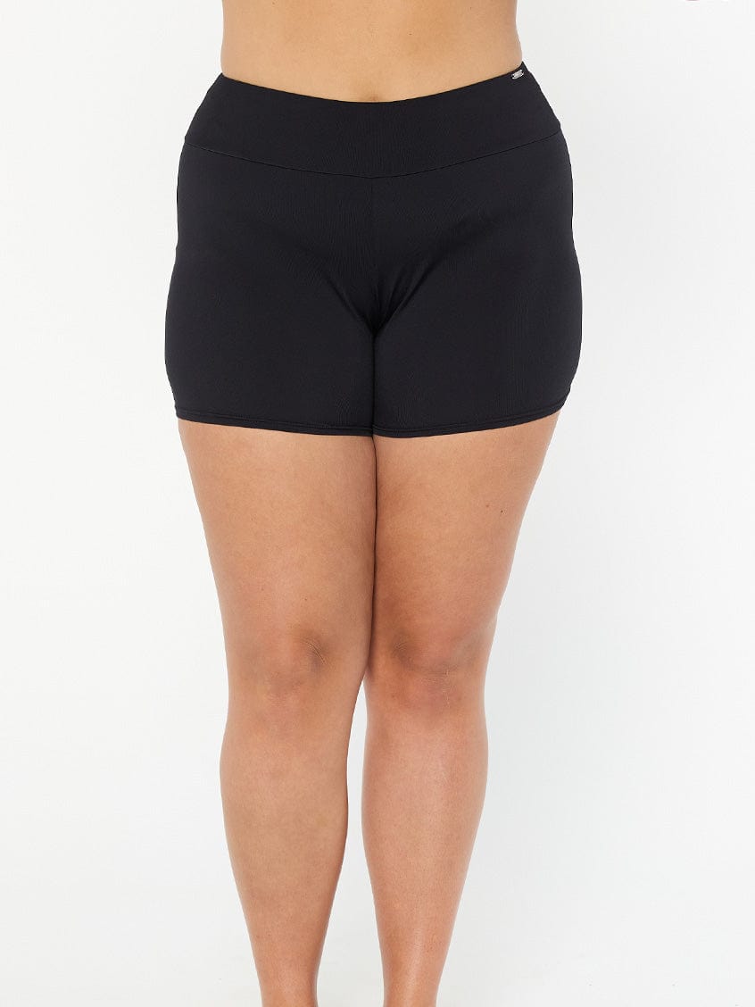 model wearing black boyleg swim shorts