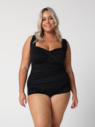 model wearing black ruched retro one piece