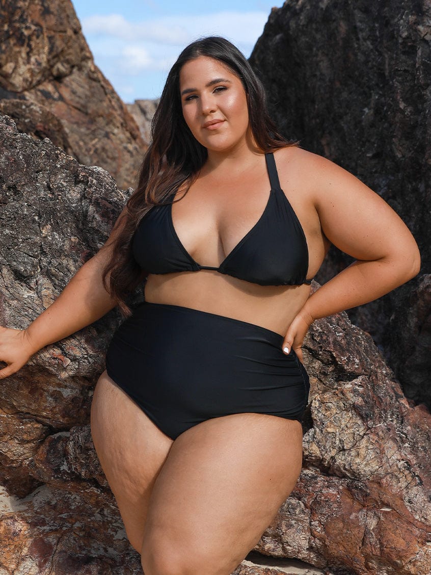model wearing black high waisted ruched swim pant