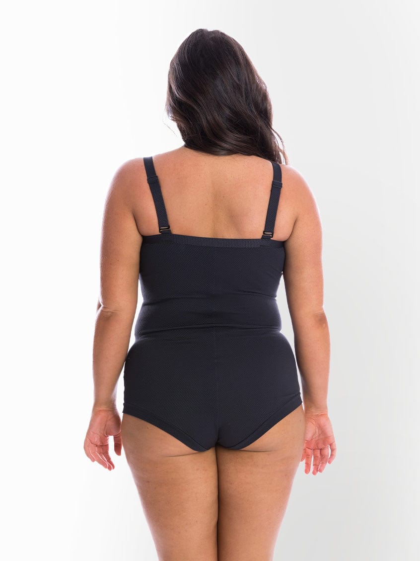 model showing back of black textured women's swimsuit