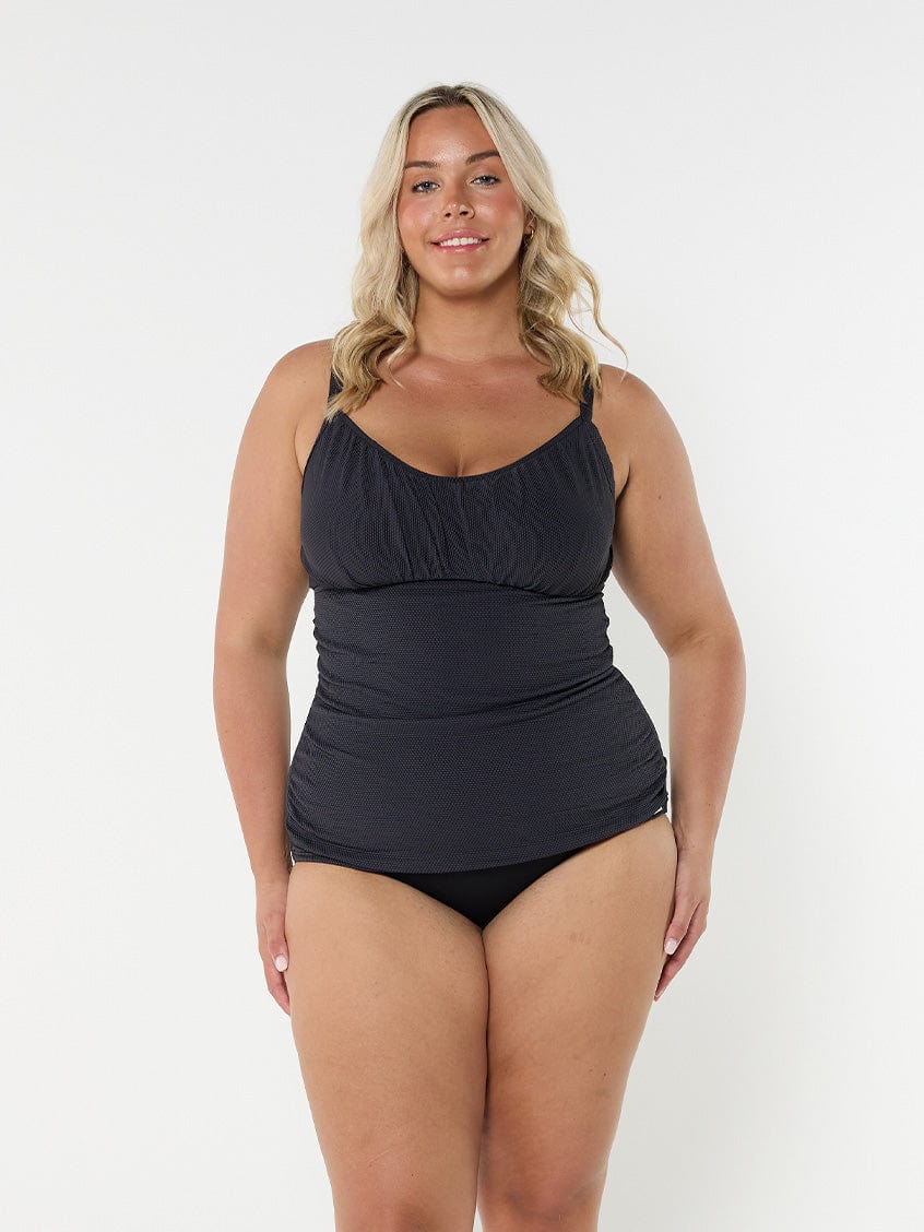 Blonde model wearing black honey comb textured underwire tankini