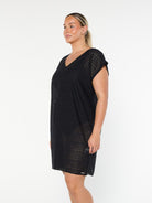 model showing side of black mesh beach dress