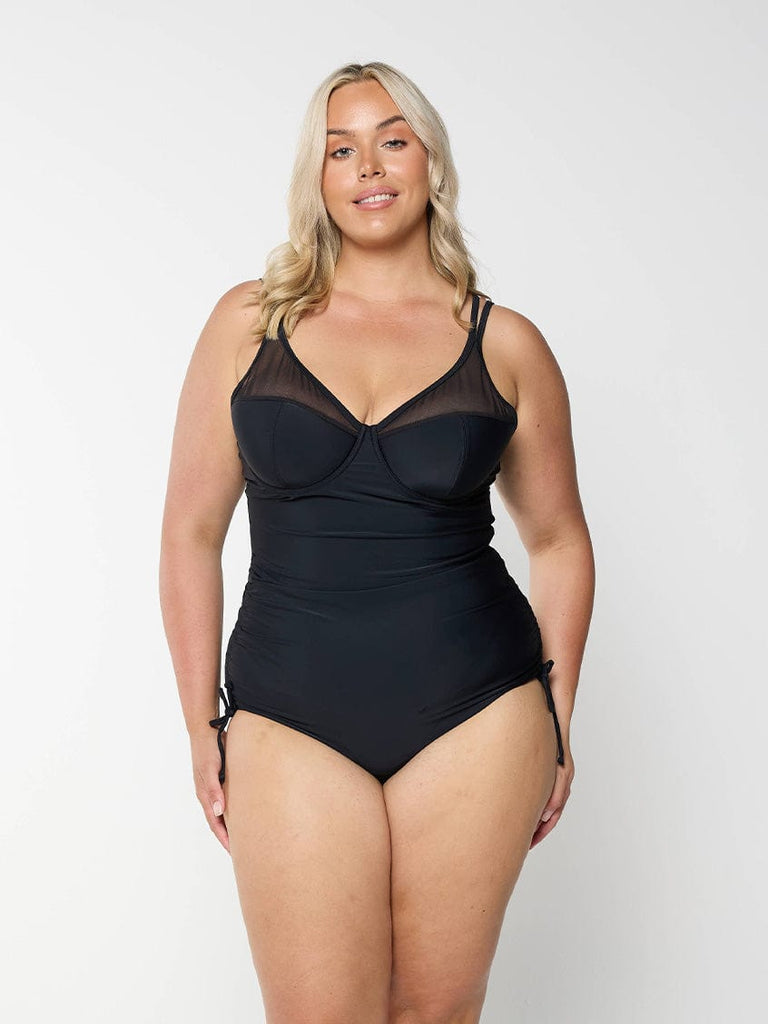 model wearing black mesh one piece with side ruching