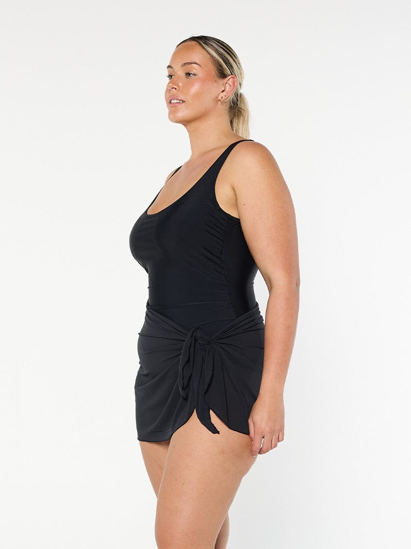 model showing side of black mesh tie side skirt