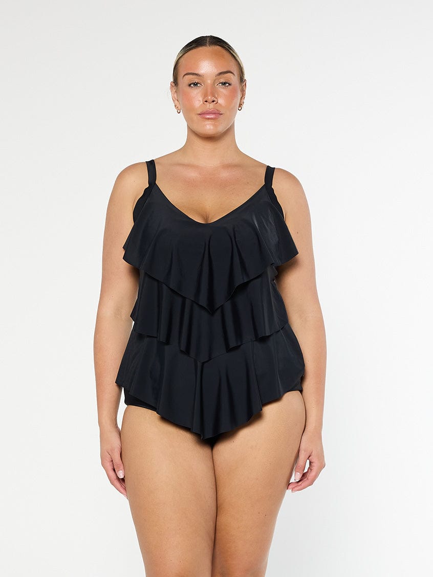 model wearing black three tier tankini top
