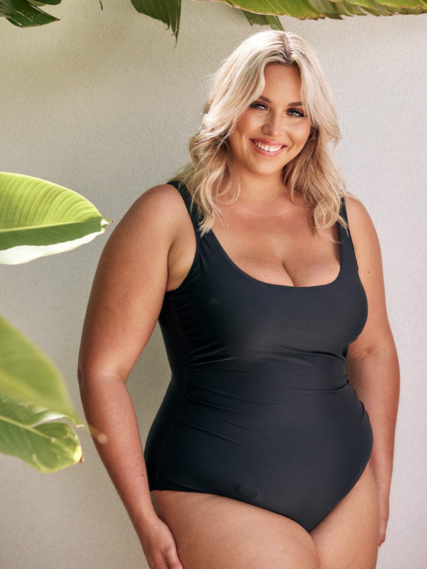 model wearing black women's swimsuit