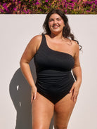 Model wearing black textured one shoulder women's swimsuit