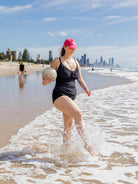 blonde model showing back of black textured tankini