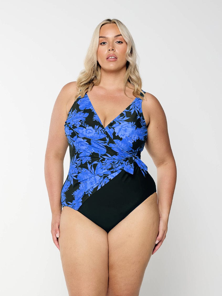model wearing blue floral waist tie one piece