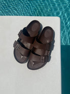 brown sandals on a diving board over pool