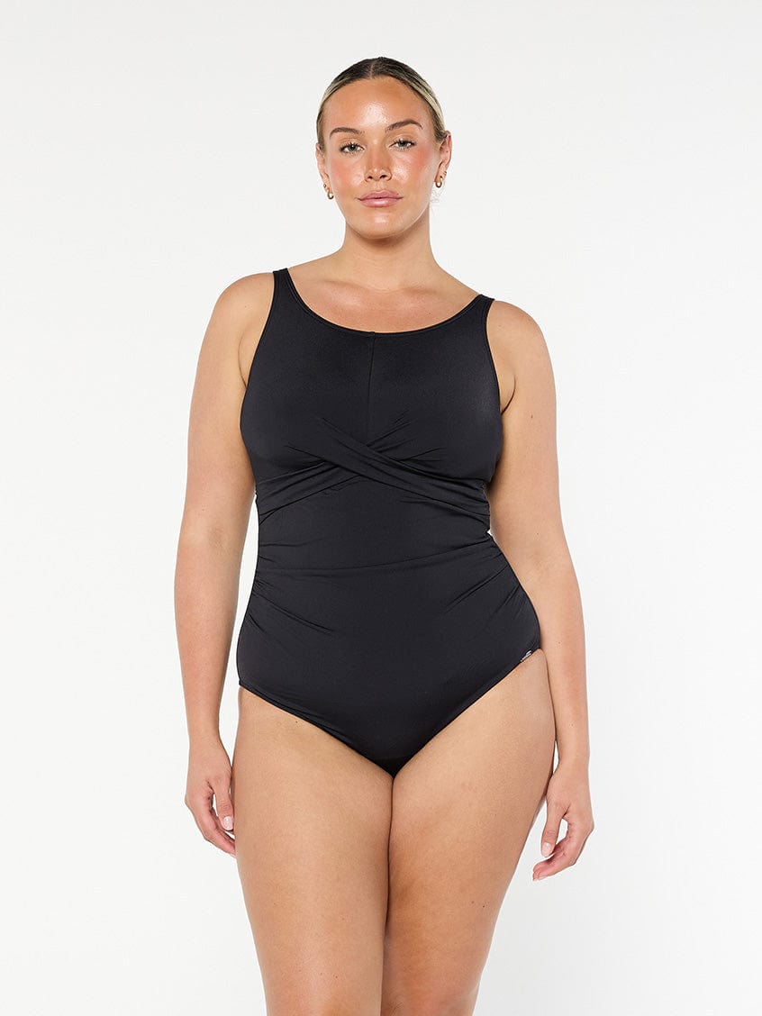 model wearing black high neck twist one piece