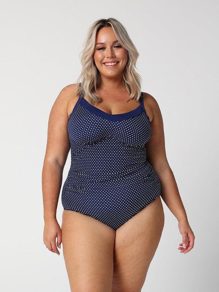 model wearing navy and white dots underwire swimsuit
