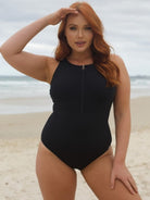 Woman in a black swimsuit on a beach