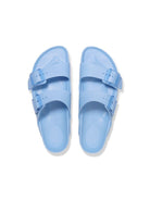 Pair of light blue sandals on a white background