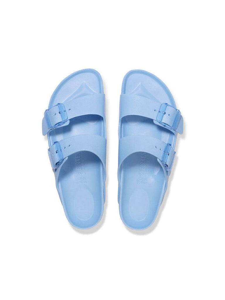 Pair of light blue sandals on a white background