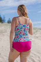 blonde model wearing bright floral tankini and hot pink pant