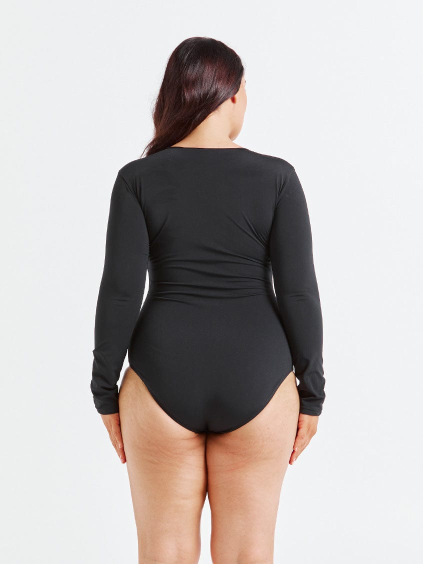 model showing back of black long sleeve one piece