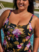 Woman wearing a floral swimsuit with a pool in the background