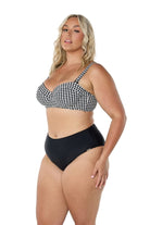 model wearing black and white print bikini top and black bottom