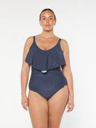 model wearing navy polka dot frill one piece