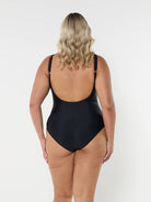 model showing low back of plain black ladies swimsuit