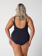 model showing back of navy textured swimsuit
