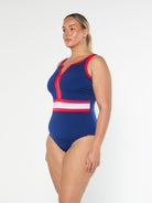 model showing side of navy and red women's one piece