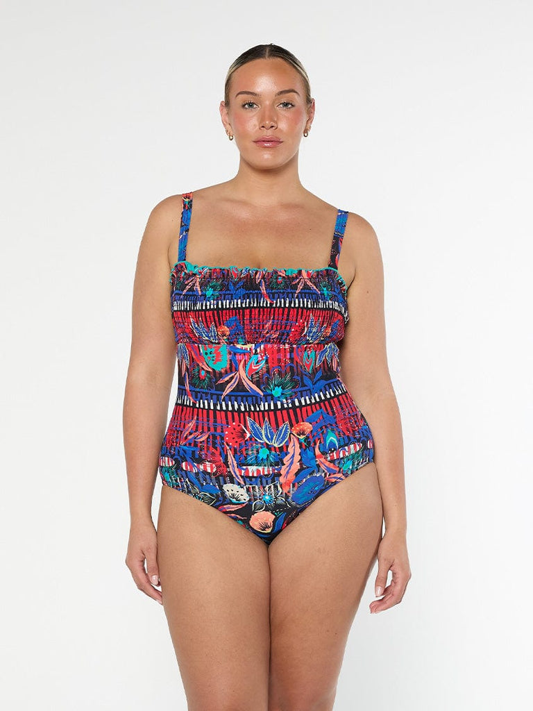 model wearing bright shirred swimsuit