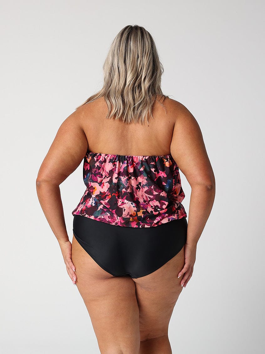 model showing back of pink floral strapless one piece
