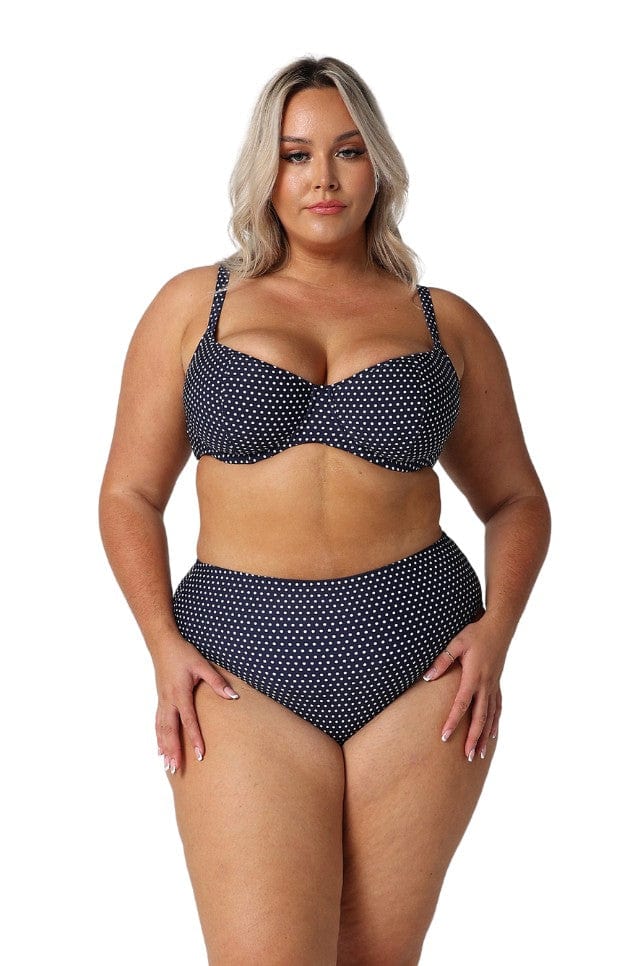 model wearing navy and white dots bikini