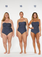 three models wearing navy polka dot strapless swimsuit