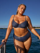 model wearing navy and white dots underwire bikini top