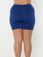 Back of model wearing knee length chlorine resistant bike pant in navy