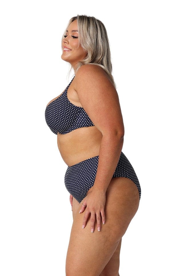 model showing side of navy and white dots swim pant