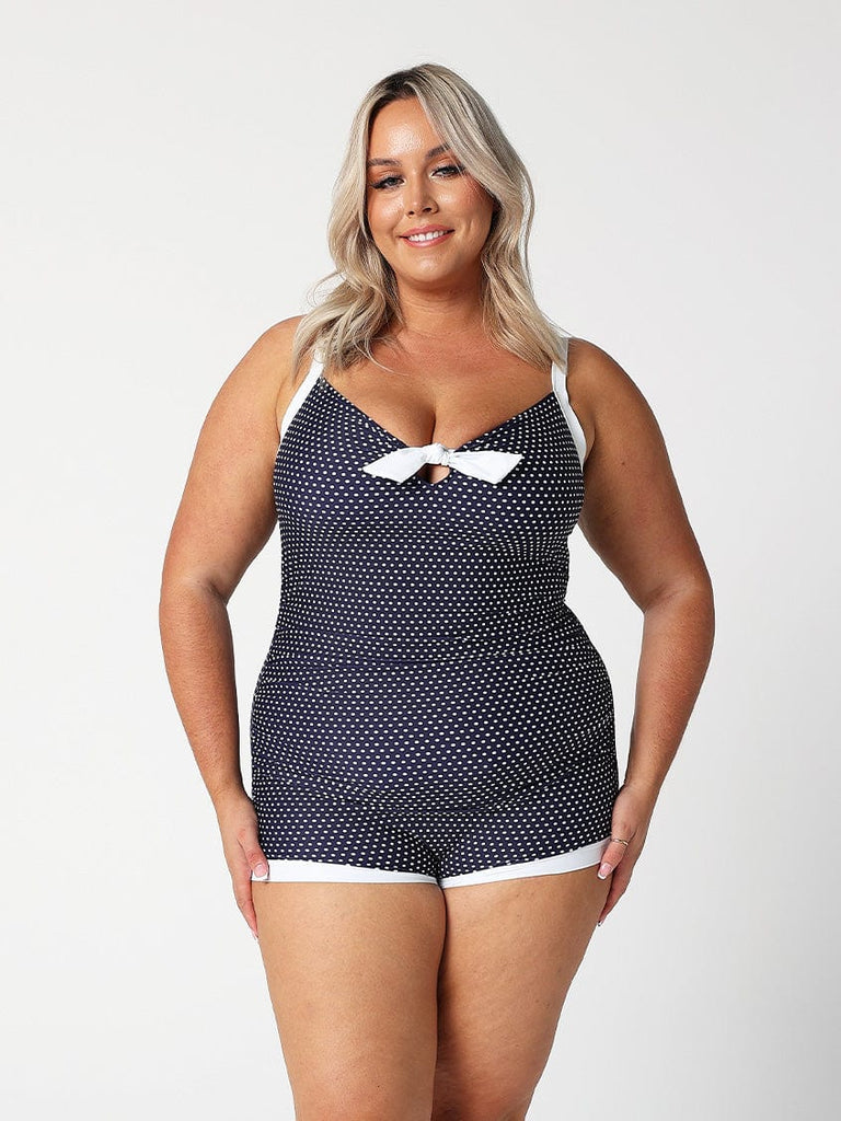 model wearing navy and white dots boyleg one piece