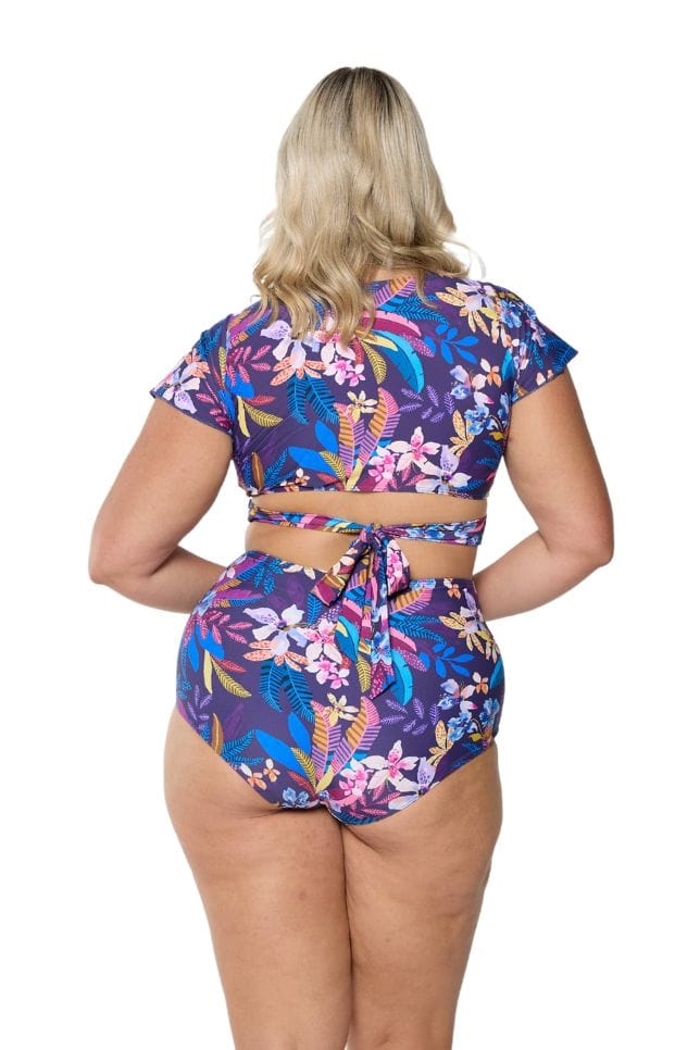 model showing back of navy tropical print high waisted pant with matching top