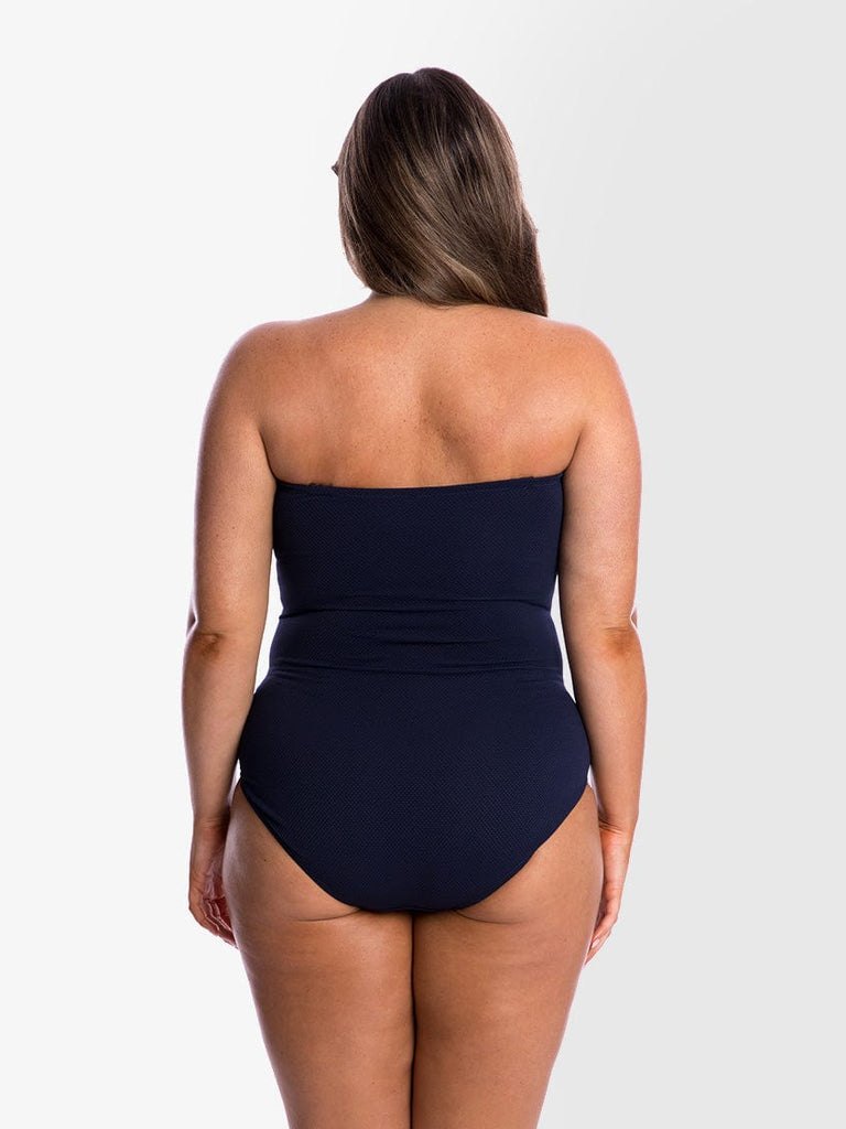 model showing back of navy textured strapless swimsuit