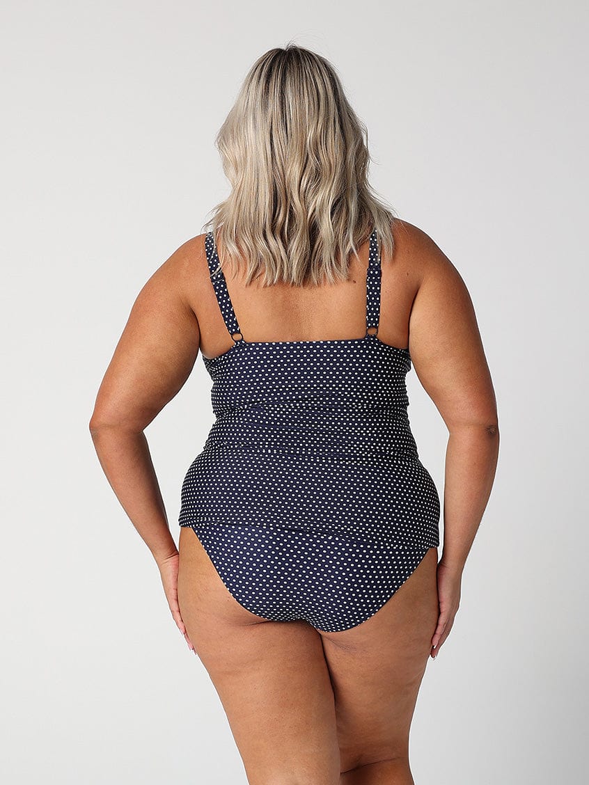 model showing back of navy polka dot swim tankini top